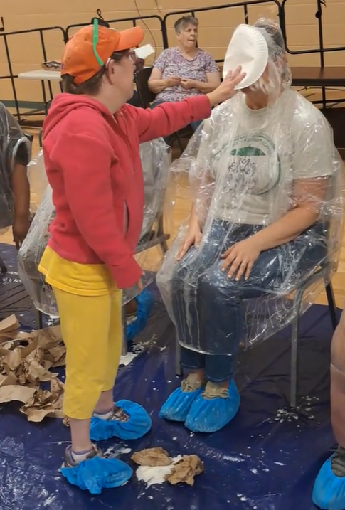 woman getting a pie in the face