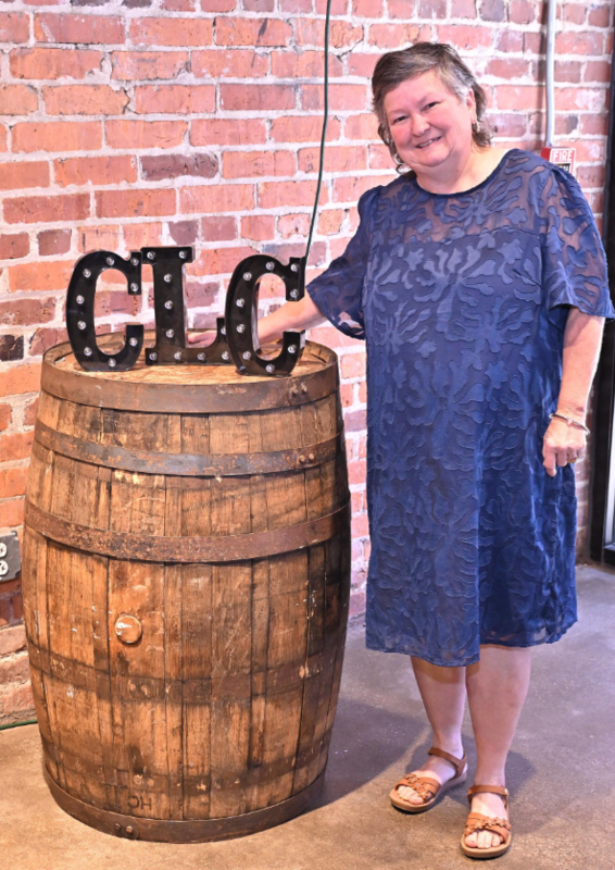 a women beside a barrll