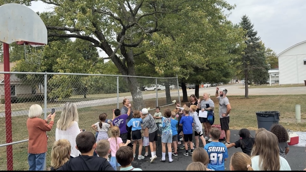 Students who sold 25 items throwing water balloons