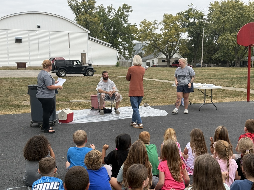 Mrs. Oakley throwing the first pie