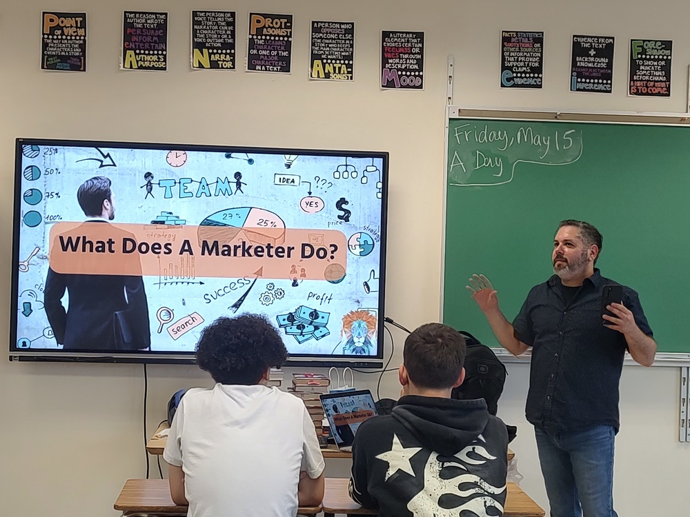 man talking to students