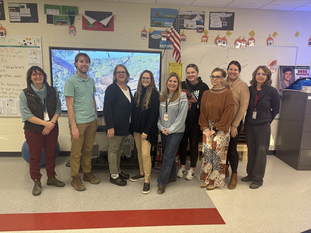 teachers and community members pose for photo
