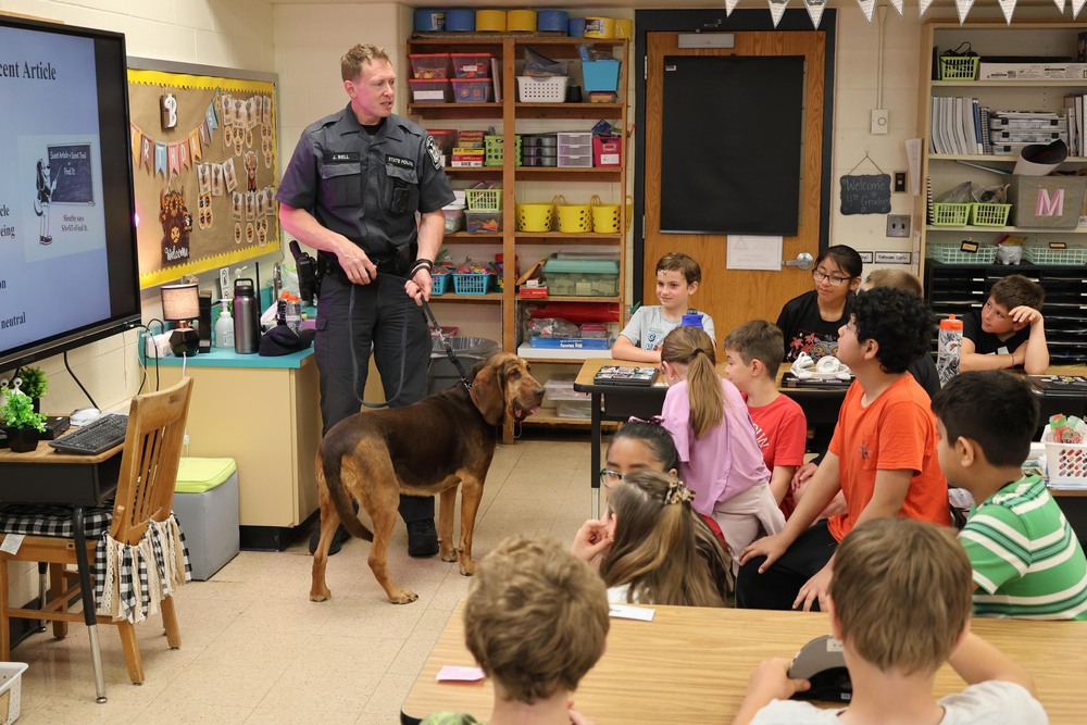 NYS trooper and Bloodhound in classroom talking to children