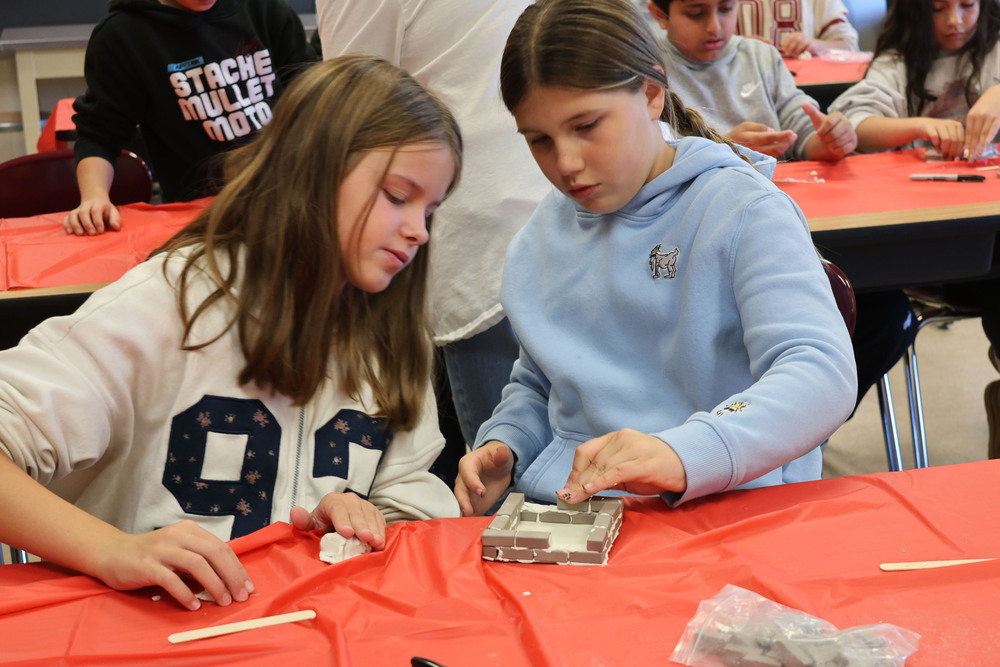 two girls building with miniature bricks
