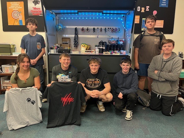 student pose with school store