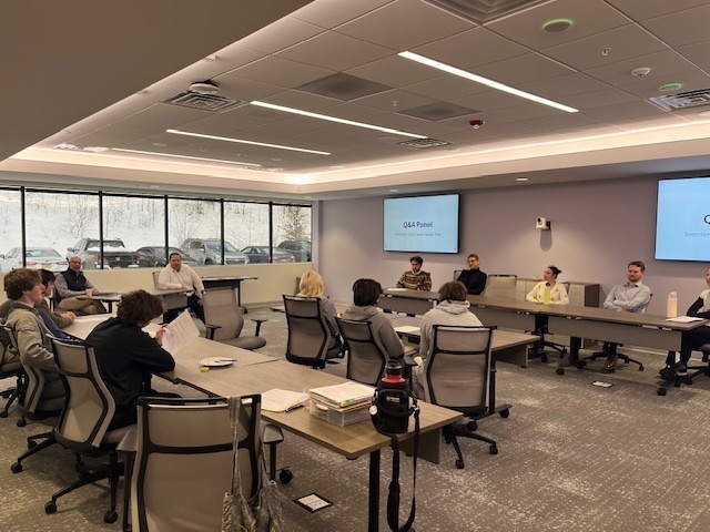 students meeting with panel