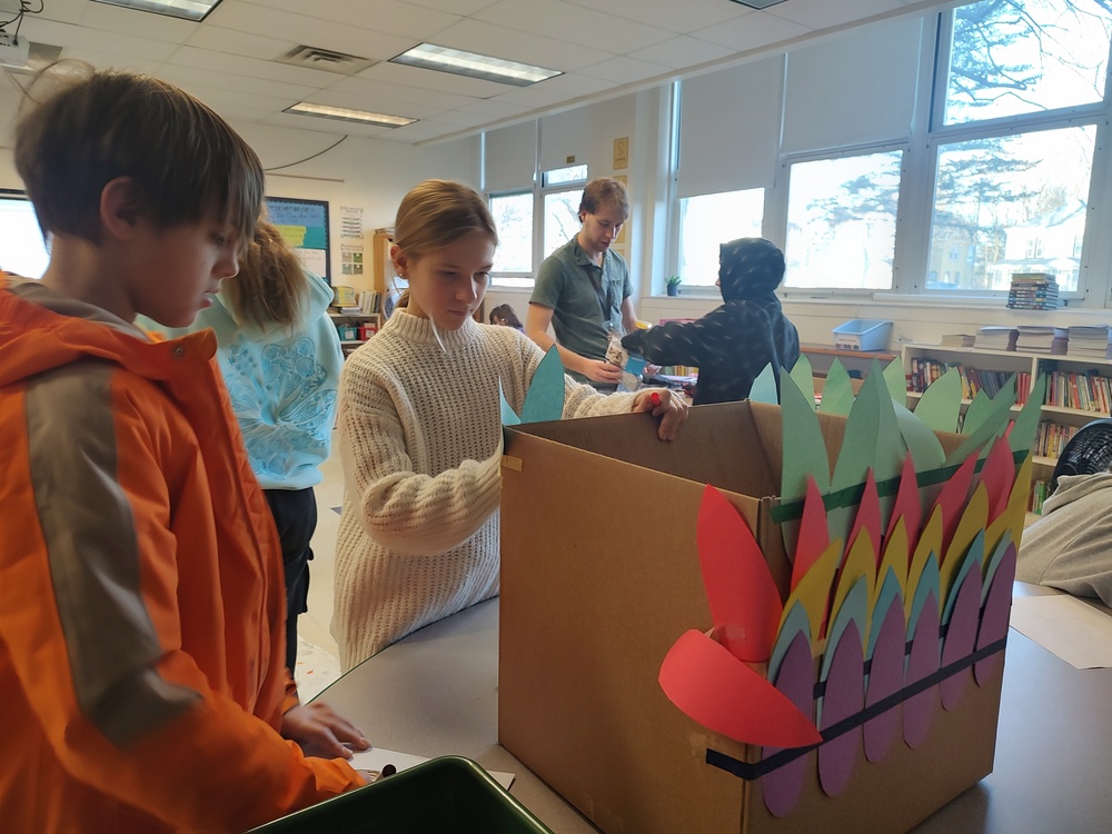 students decorating boxes with Thanksgiving theme
