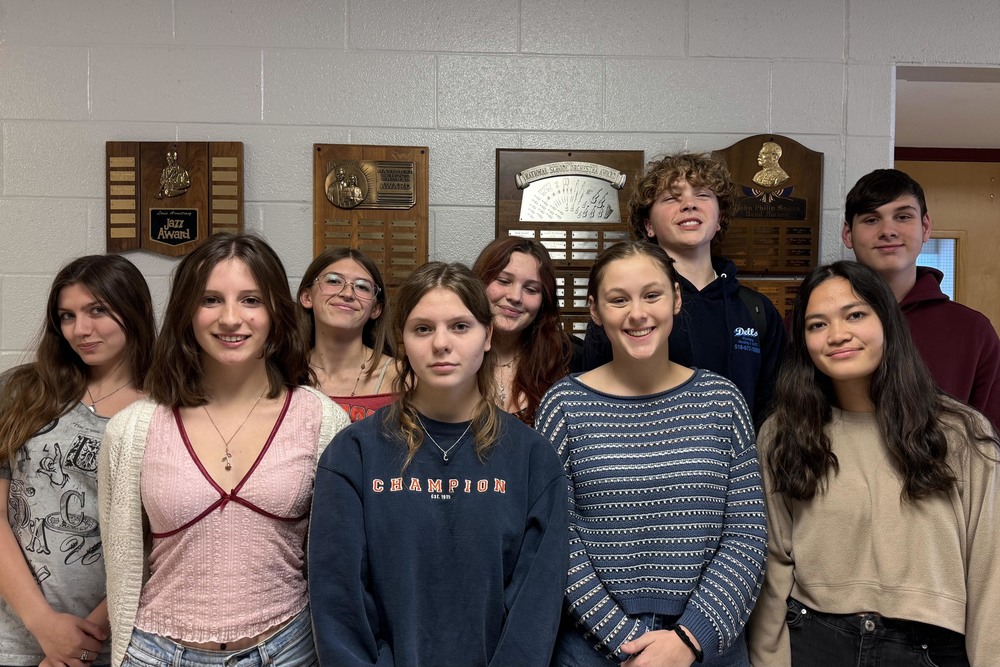 nine students posing for group photo