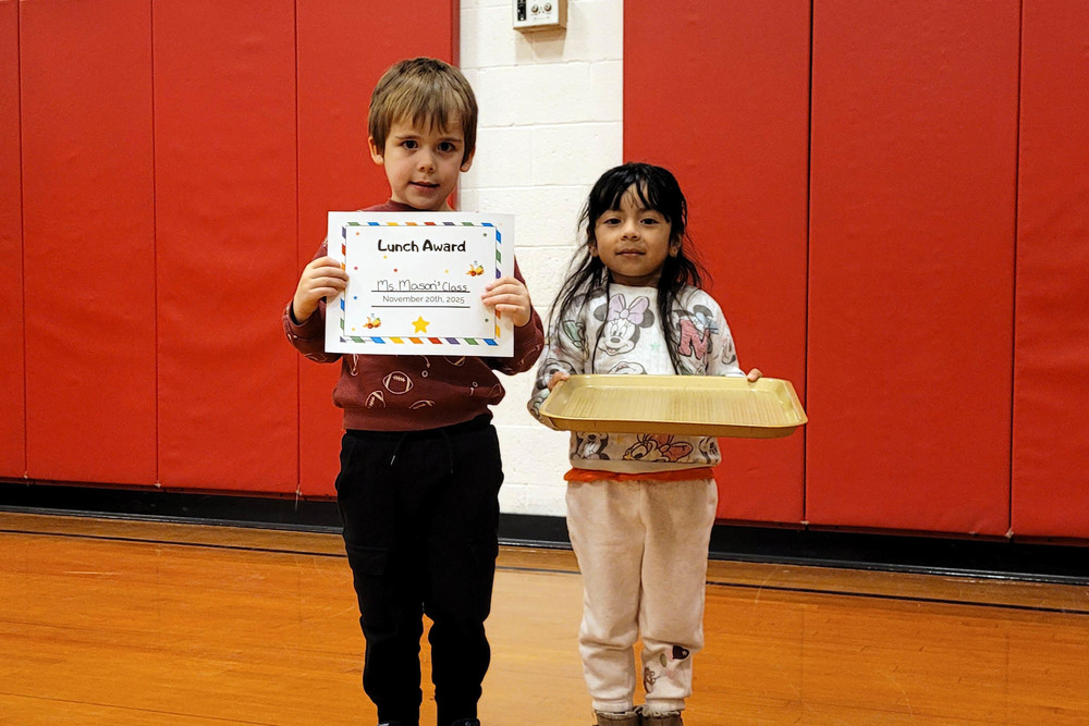 boy and girl posing for photo with certificate and lots of smiles