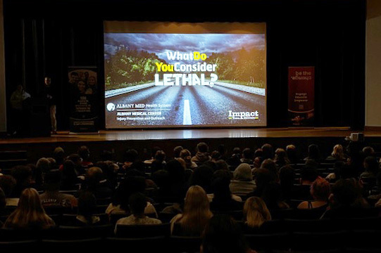 Students watching video in auditorium