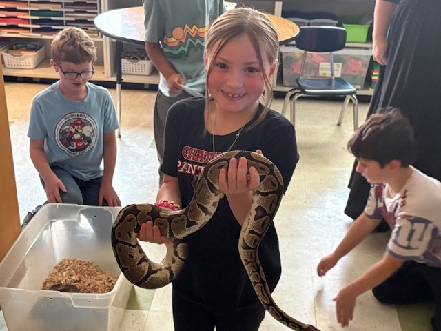 girl holding snake
