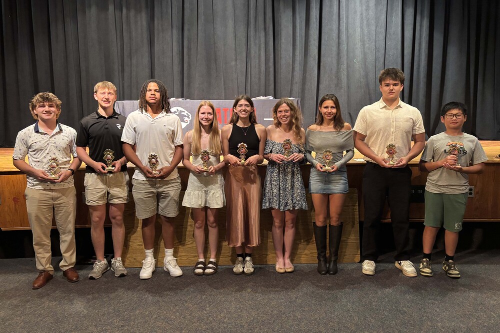 Chatham High School's sports awardees pose for group photo holding trophies 