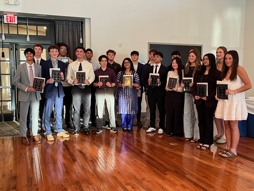 outstanding business student awardees pose for group photo with awards