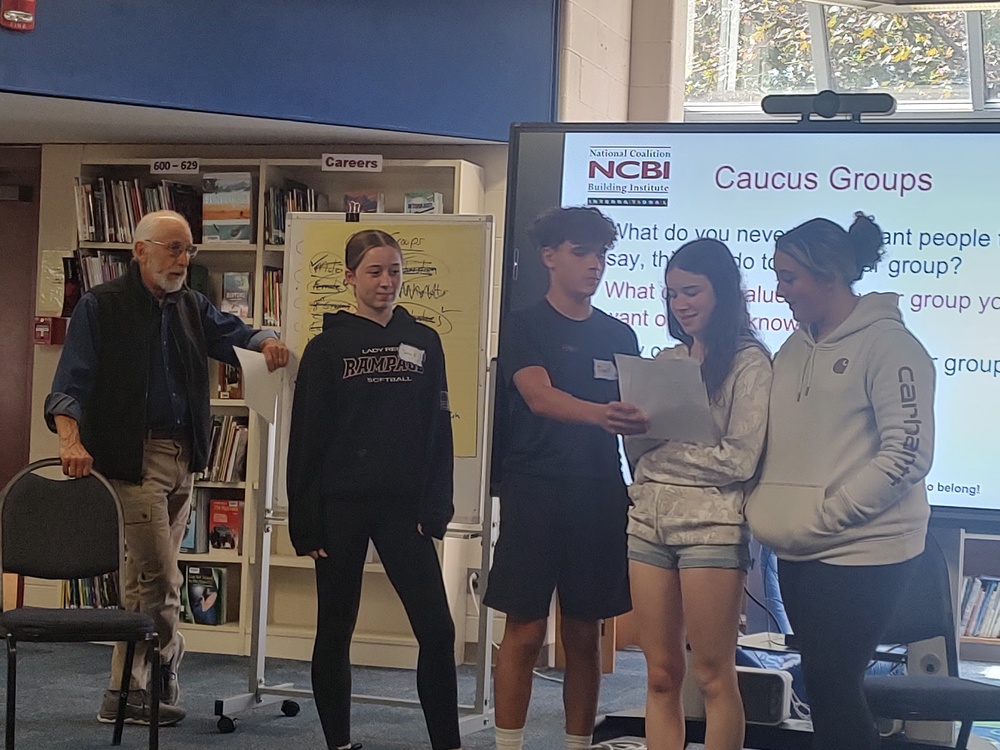 students reading from piece of paper