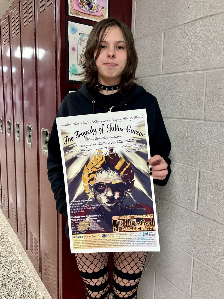 student holding poster advertising The Tragedy of Julius Caesar