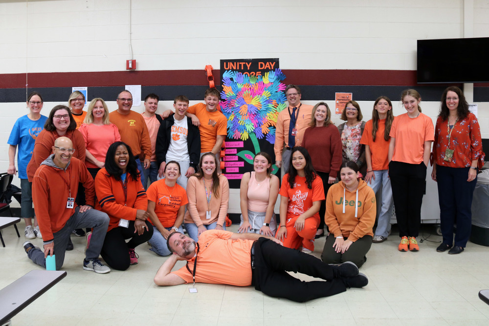 group of staff and students wearing orange