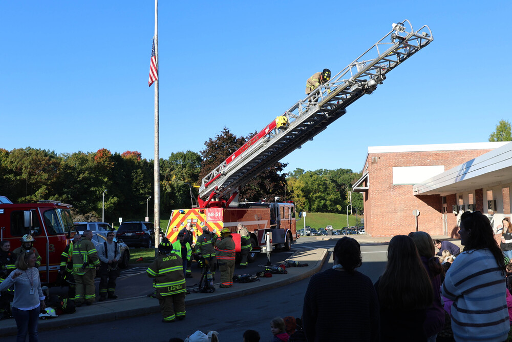 firefighter climbing on ladder truck