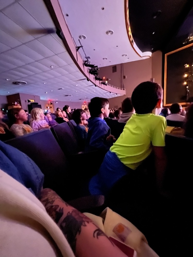 student watching play in theater