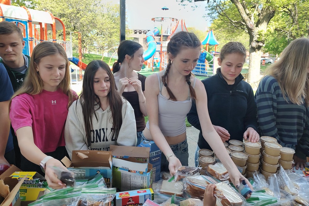 students sorting sandwiches at table