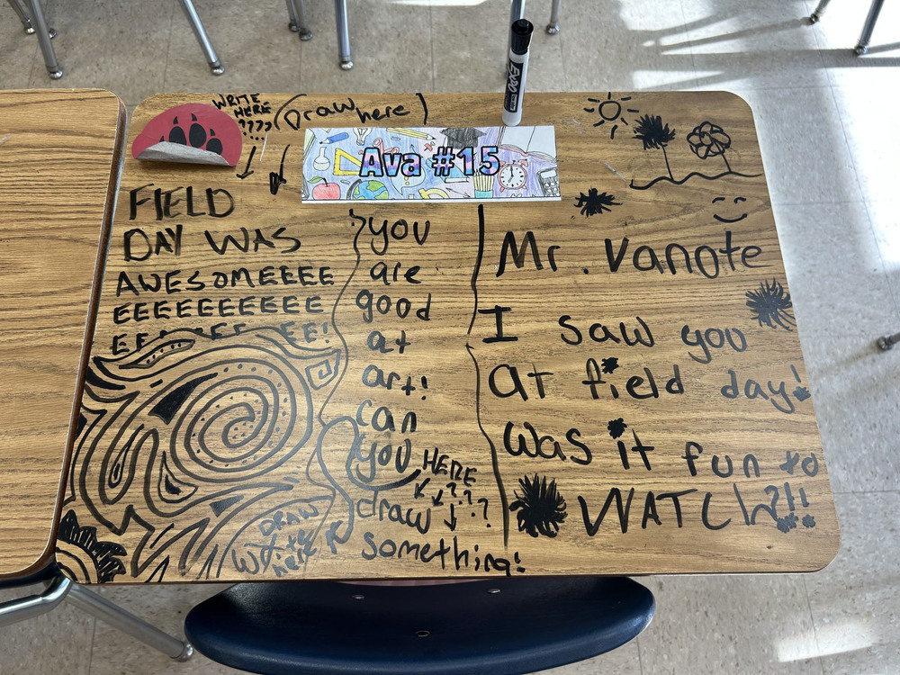 desk with writing and drawing on it