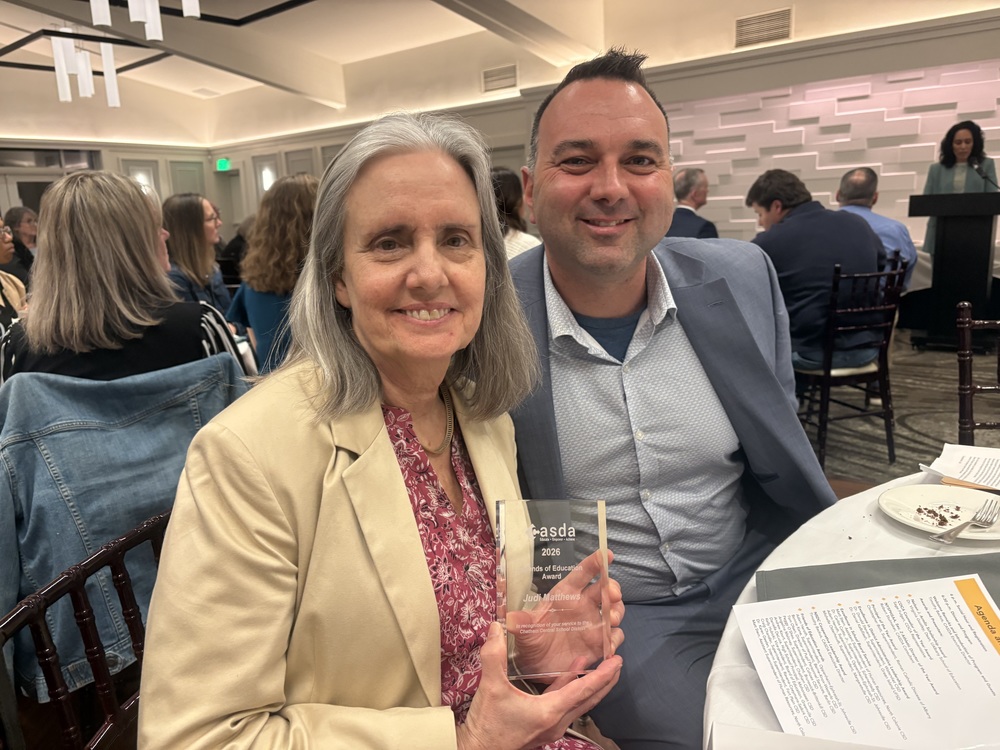 Judi Matthews and Andrew Kourt pose with award