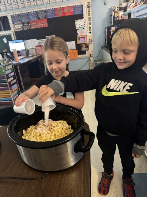 boy and girl pouring sugar into crockpot filled with apples
