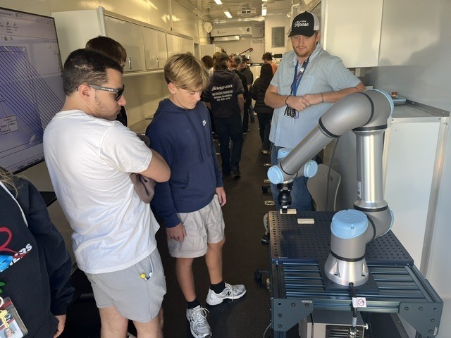 students look at robot