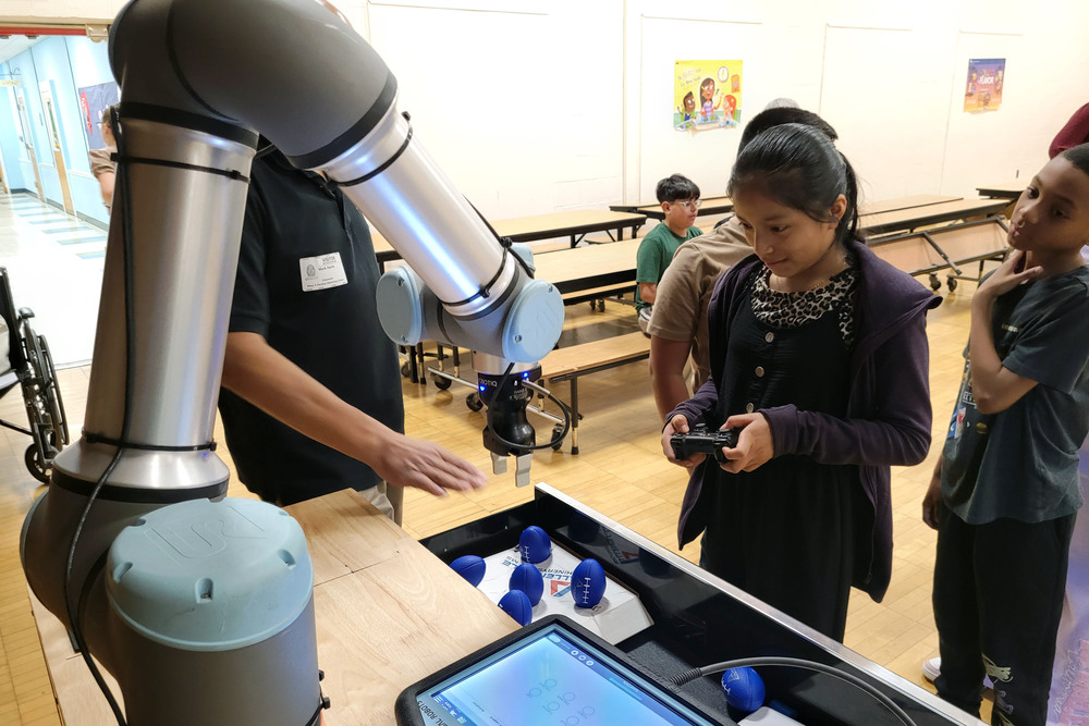 girl operating robotic arm