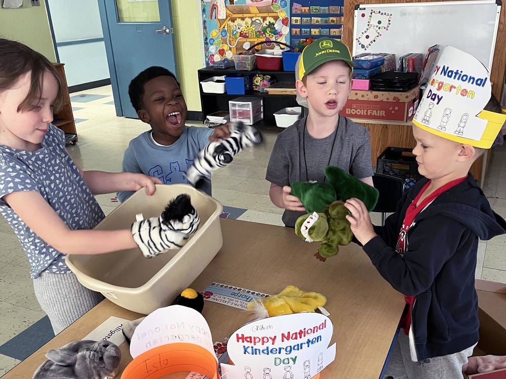 students playing with puppets