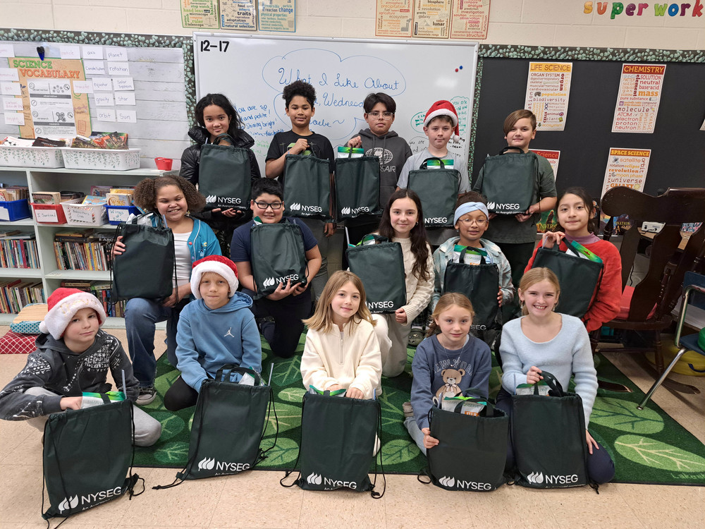 group photo of students holding NYSEG bags