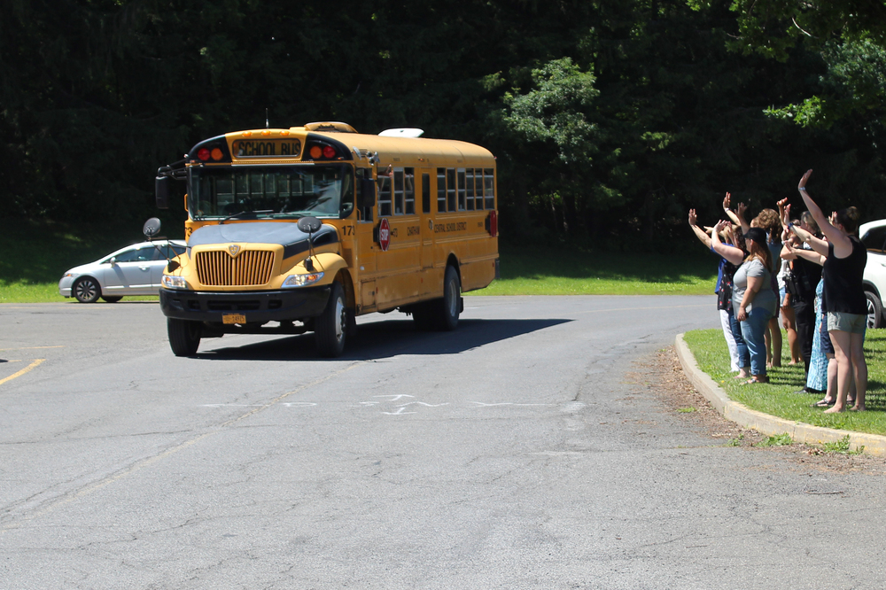 teachers waving to school bus