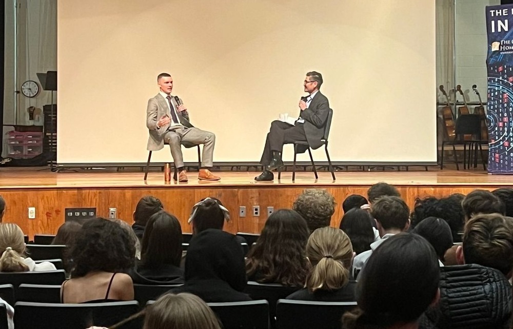 two men in suits on CHS stage