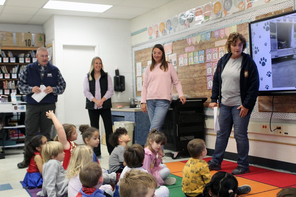 transportation staff talk to pre-k children