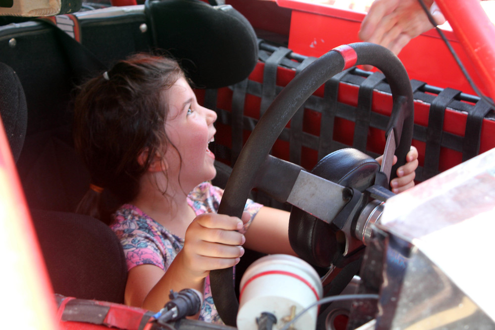 girl sitting in race car