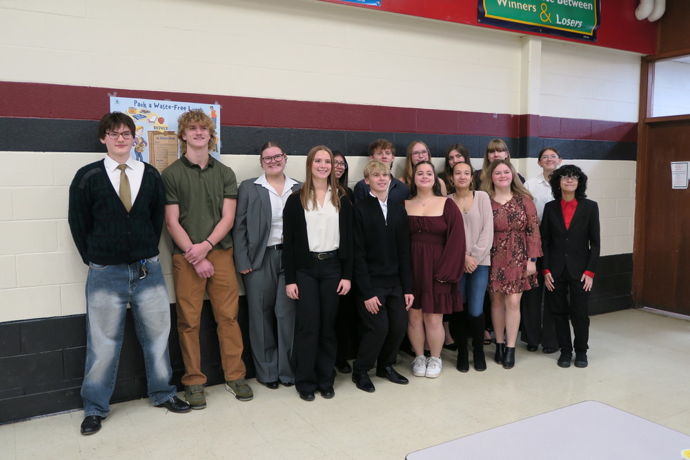 students in business attire pose for group photo