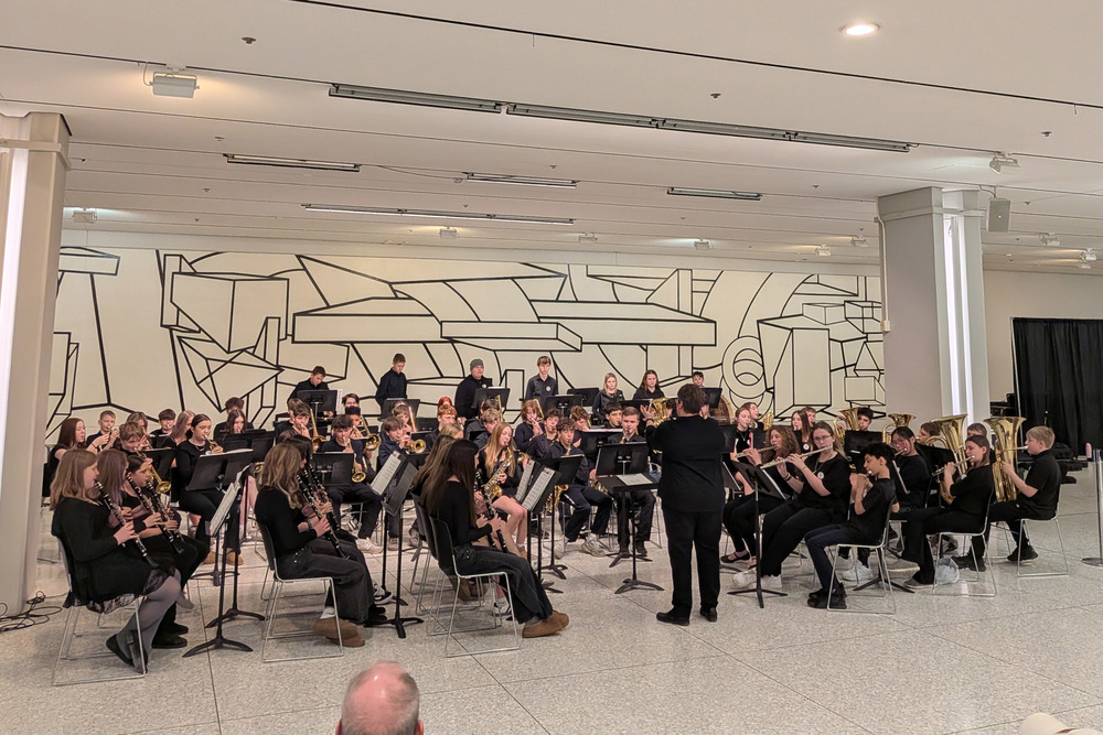 grade 7/8 orchestra performing in the South Concourse