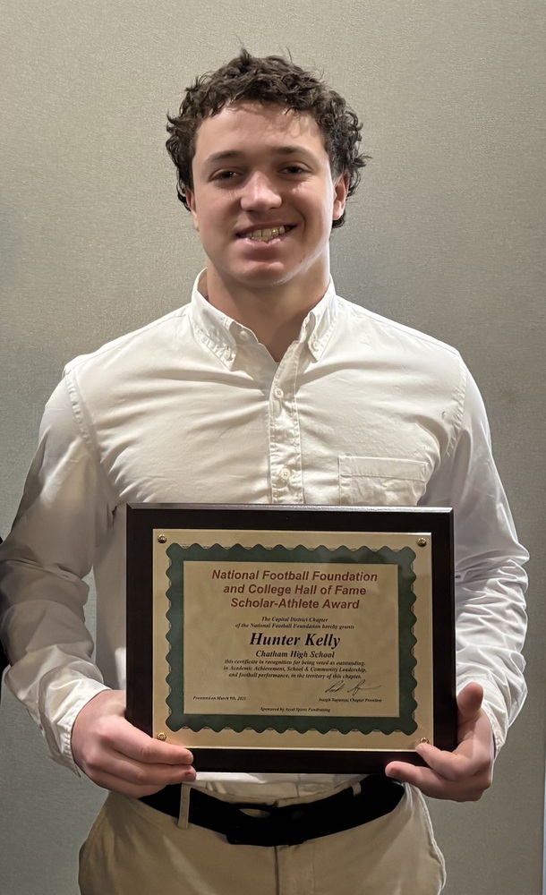 Youn man holding framed certificate