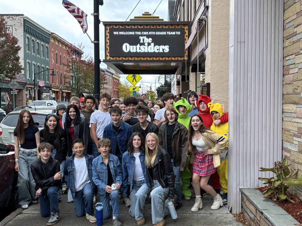 students pose for photo outside Crandell Theatre