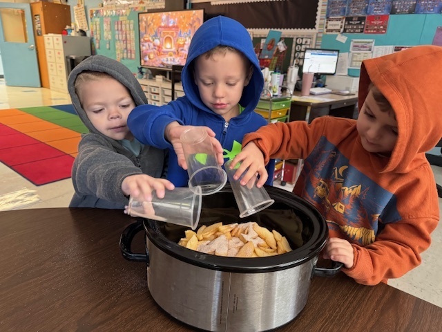 three boys making applesauce