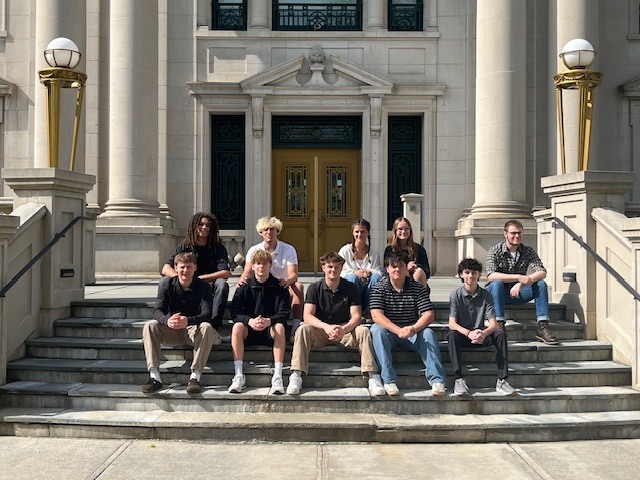 group of students seated on Colombia County Courthouse steps