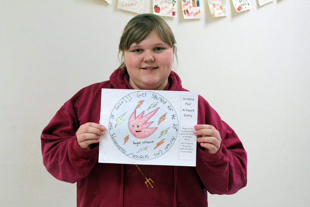 girl holding drawing of a spark