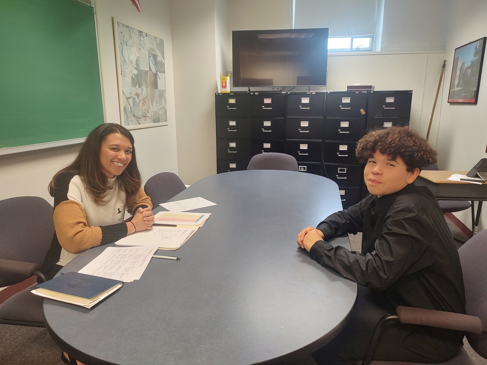 young woman interviewing teenage boy