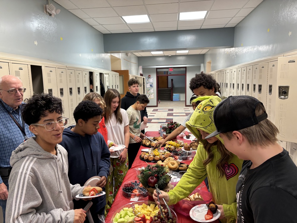 studens getting breakfast at buffet set up in hallway