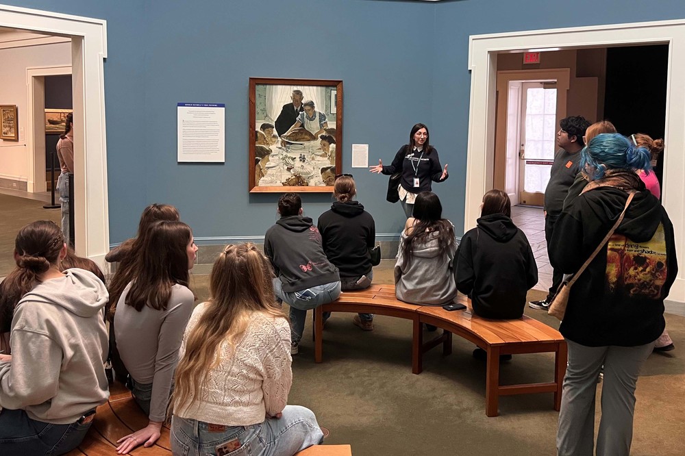 docent explaining painting to group of students