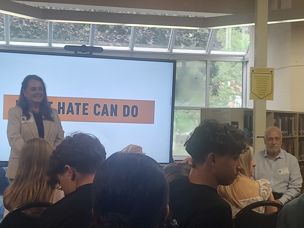 woman and man presenting to students in library
