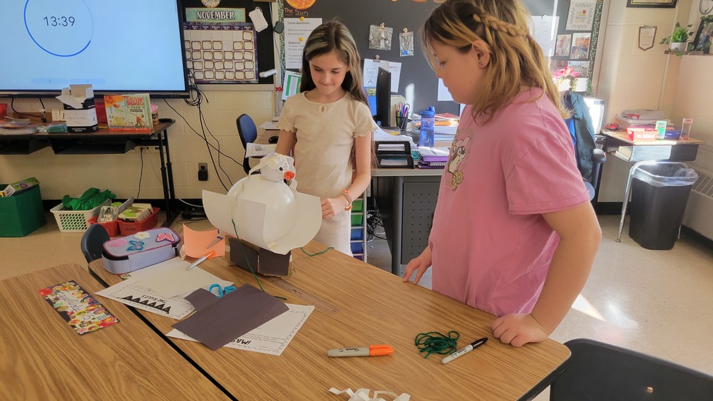 teo girls making balloon float model