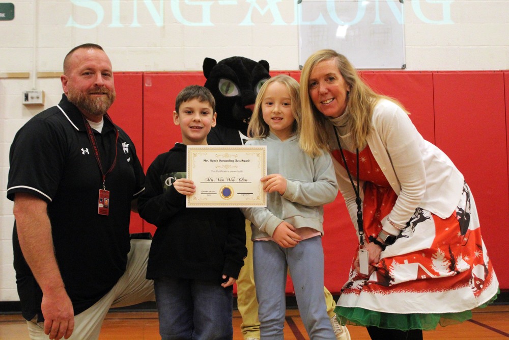 man, woman boy, girl and panther mascot pose with picture with award certificate