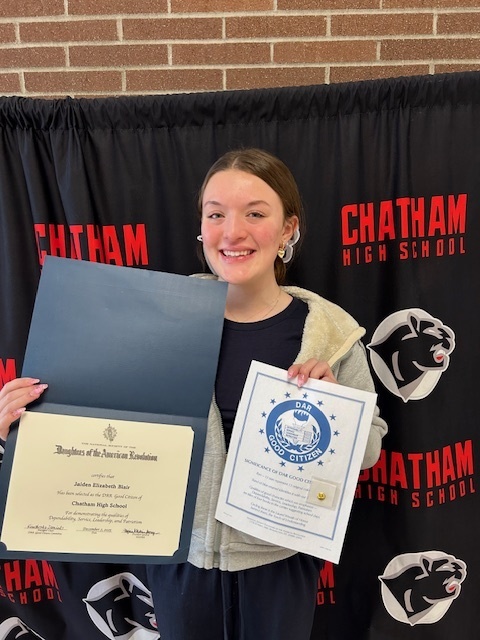 Young woman holding award certificate from the Daughters of the American Revolution