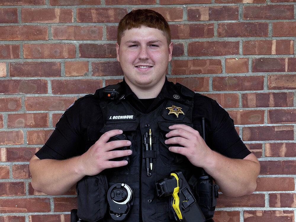 smiling young man in police uniform 