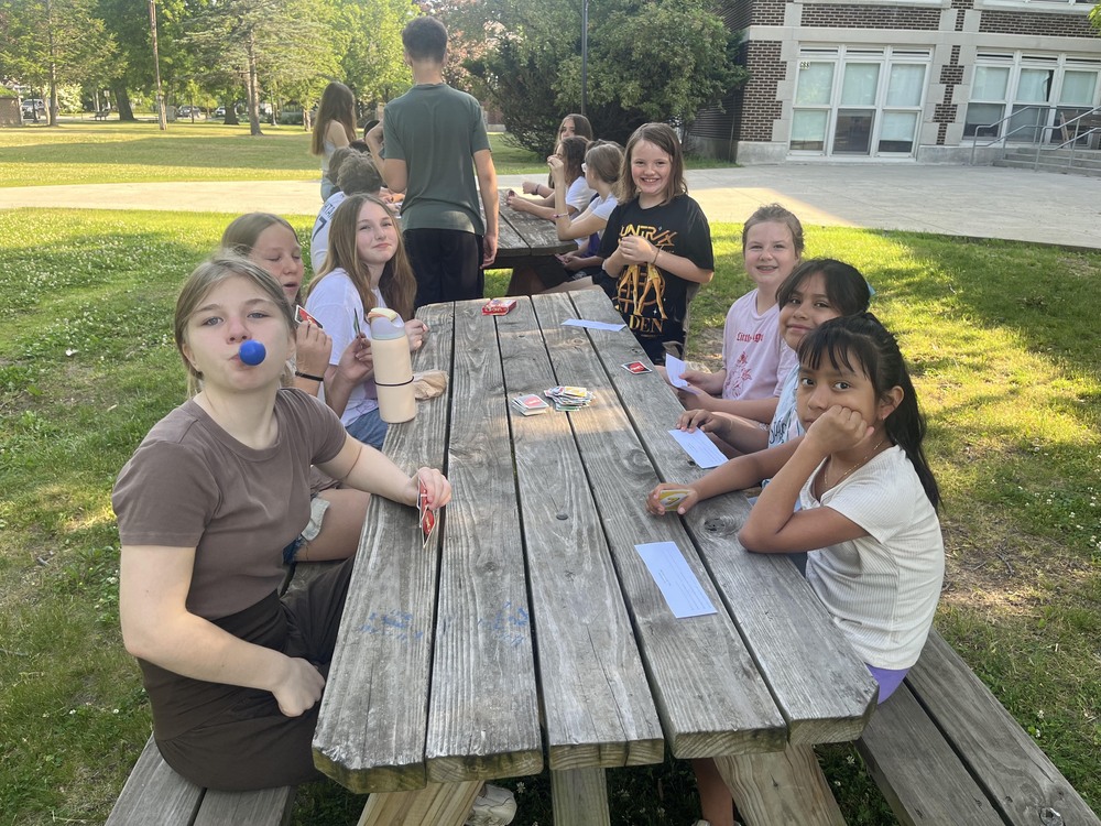 girls sitting at picnic tables